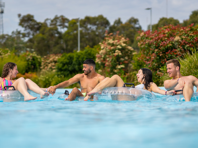 Friends in the pool in tubes